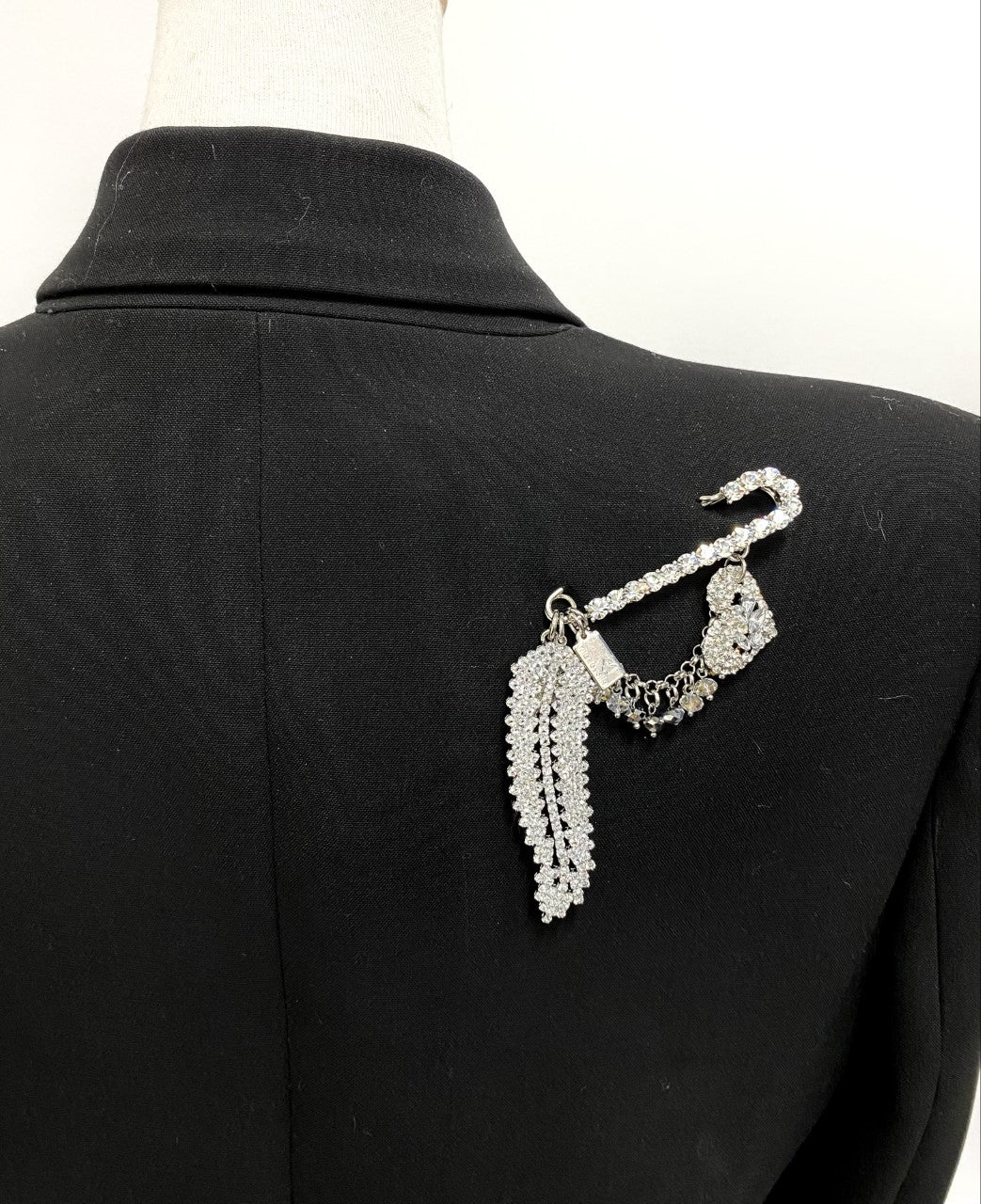 Crystal pin, crystal feather, heart, star and cascades.  Artistic, exclusive, and handcrafted, this piece is a unique and collectable work of art. Crafted with the finest quality materials, it is made in Toronto.