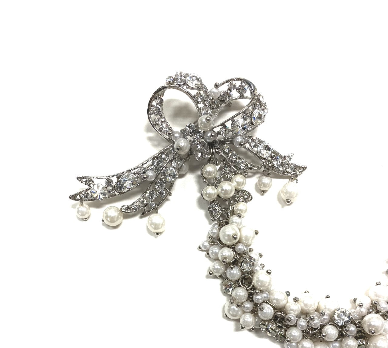 Artistic, exclusive, handcrafted, and one-of-a-kind. Collectable, finest quality, made in Toronto, Canada. Woman-owned and operated.  Crystal Bow, Austrian Crystal, Pearl, Brooch